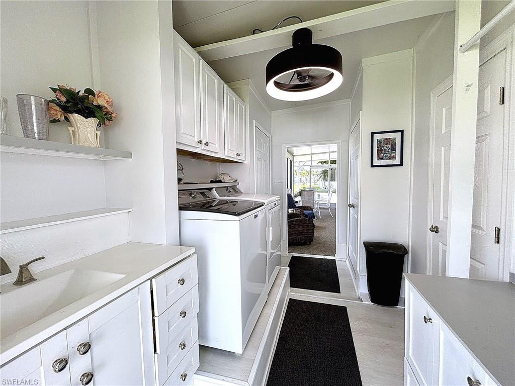 Laundry area with built-in cabinetry, washer and dryer, and a glass-paneled exterior door