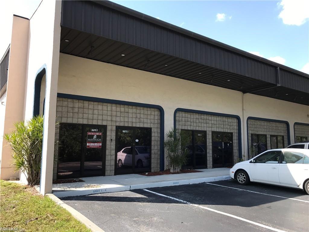 Commercial building featuring a dark corrugated metal awning, glass block accents, and multiple entryways