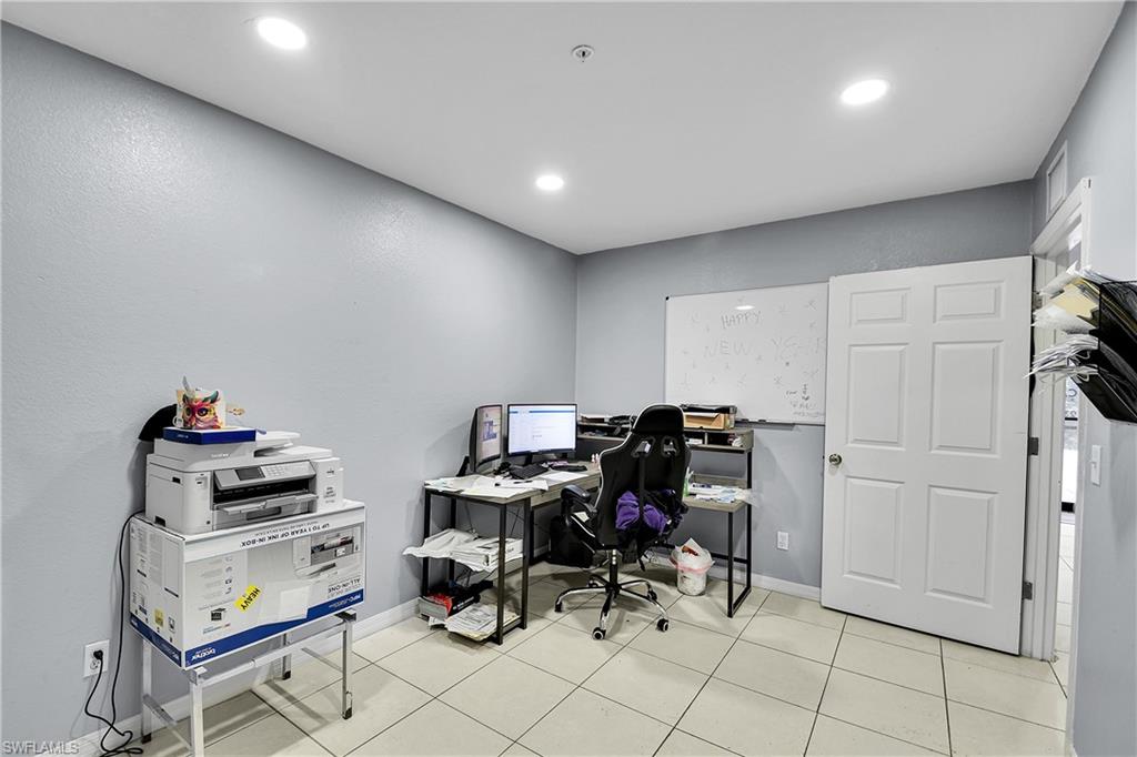 Neutral-toned room with recessed lighting and light-colored tile flooring