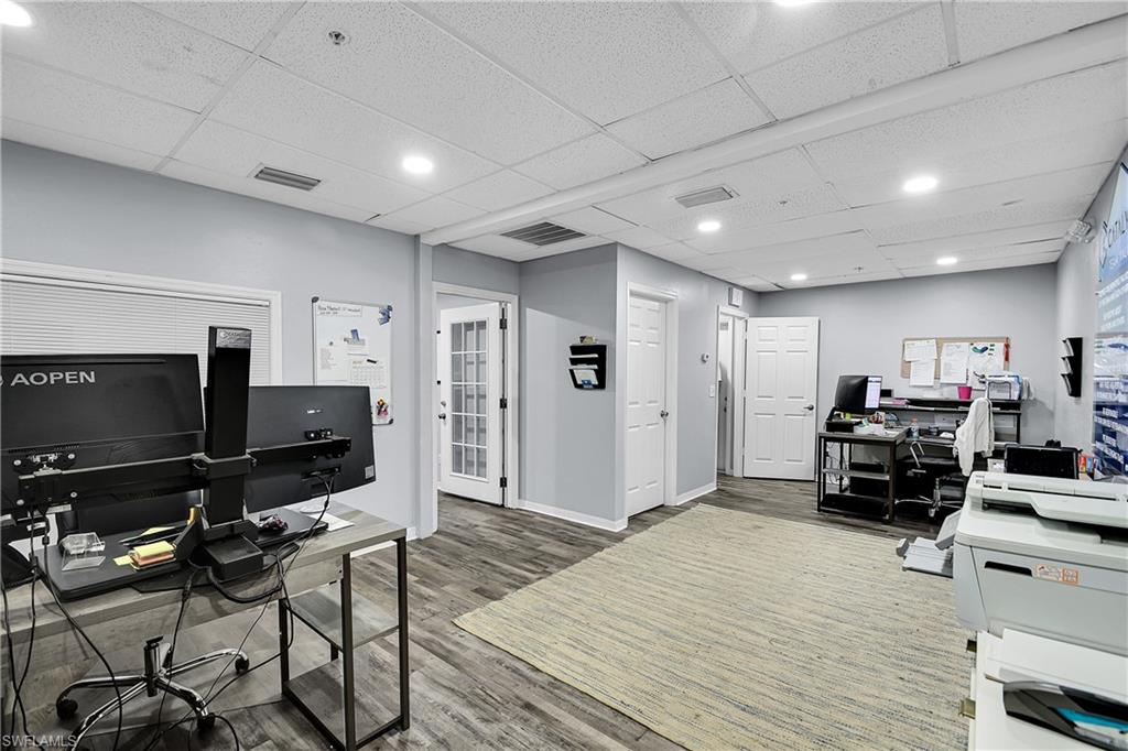 Spacious interior with wood-finish flooring and light gray painted walls