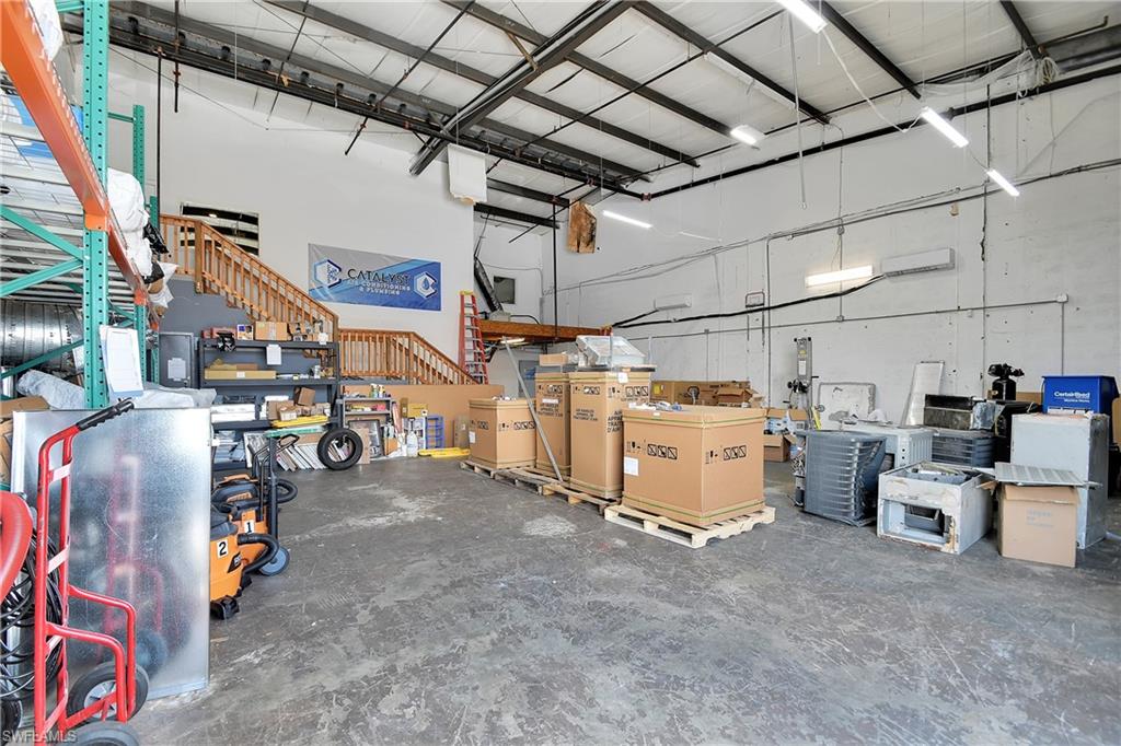 Spacious interior with concrete flooring and exposed ceiling beams