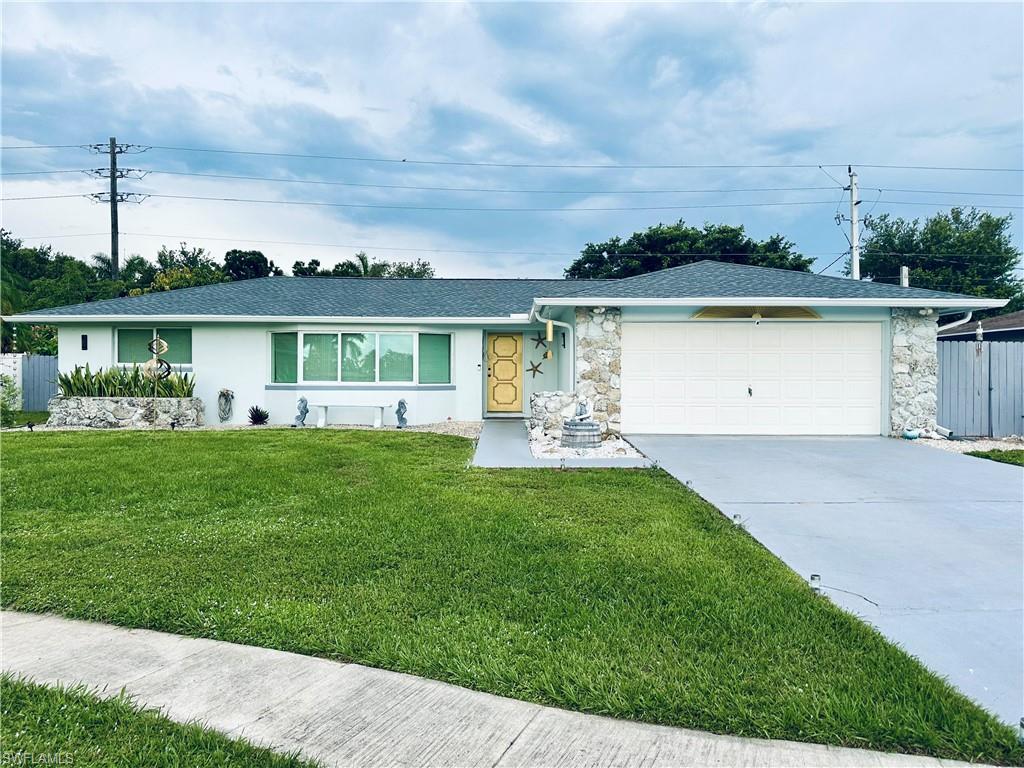 Single-story residence featuring a white exterior and a dark shingle roof