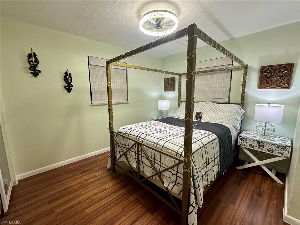 Wood-finish flooring throughout this room with light green walls