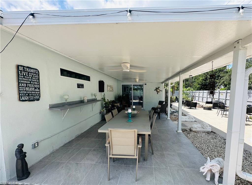 Expansive covered patio featuring a ceiling fan, recessed lighting, and string lighting