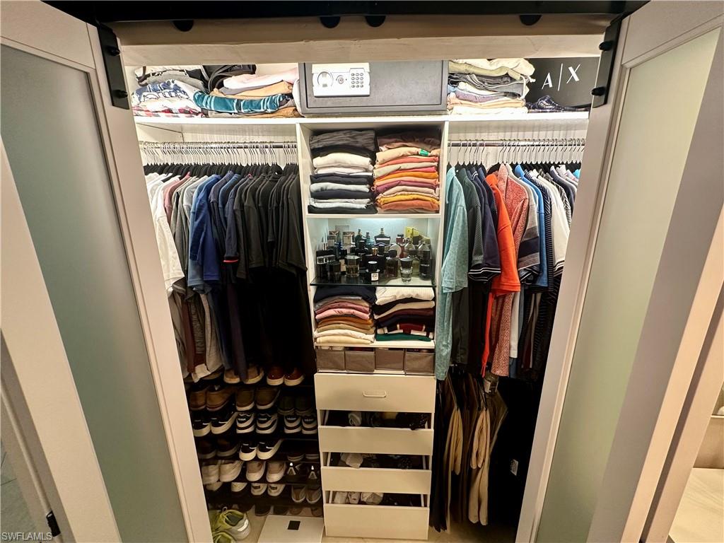 Custom closet system featuring frosted glass sliding barn doors