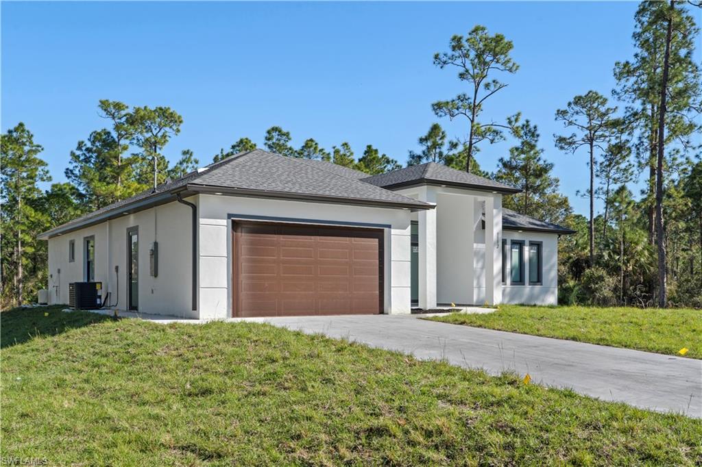Modern exterior featuring a prominent brown garage door and a concrete driveway