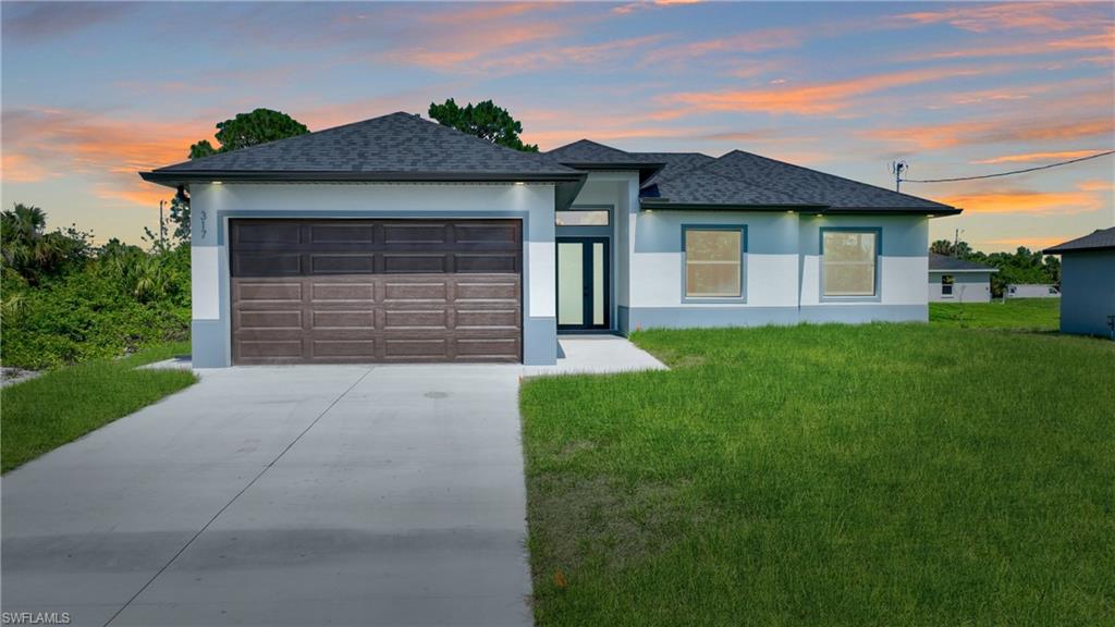 Contemporary single-story residence with a dark shingle roof and a two-tone exterior finish