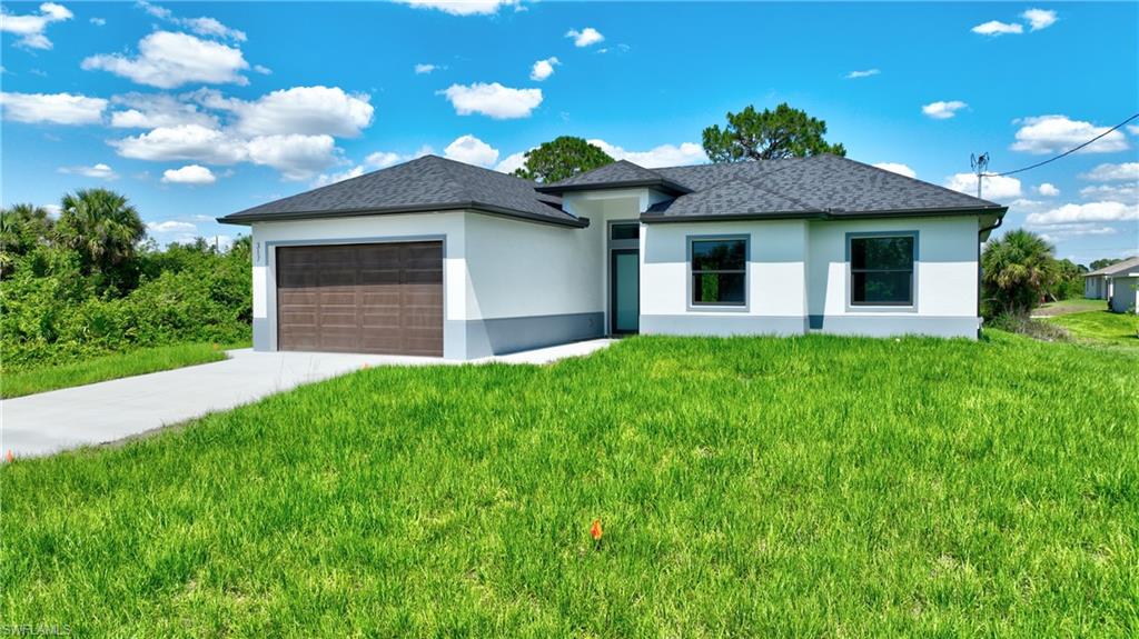 Contemporary single-story stucco residence featuring a dark shingle roof, integrated garage with a wood-finish door, a concrete driveway, and gray window frames
