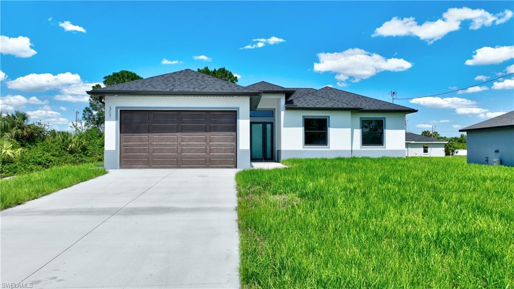 Modern exterior featuring a dark wood-finish garage door, white stucco facade, and dark roof shingles