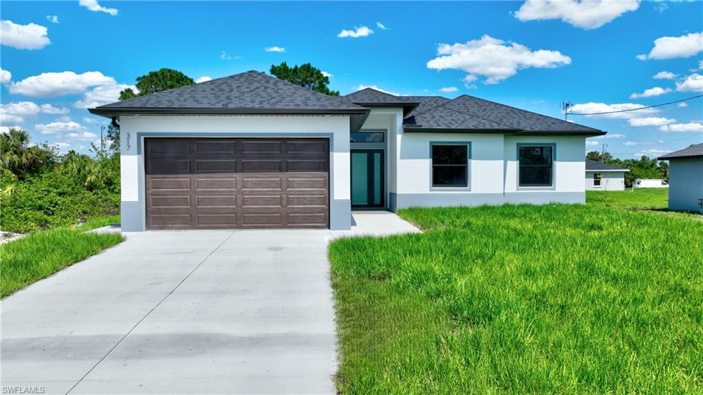 Contemporary stucco exterior with a two-car garage, dark gray shingle roof, and a concrete driveway