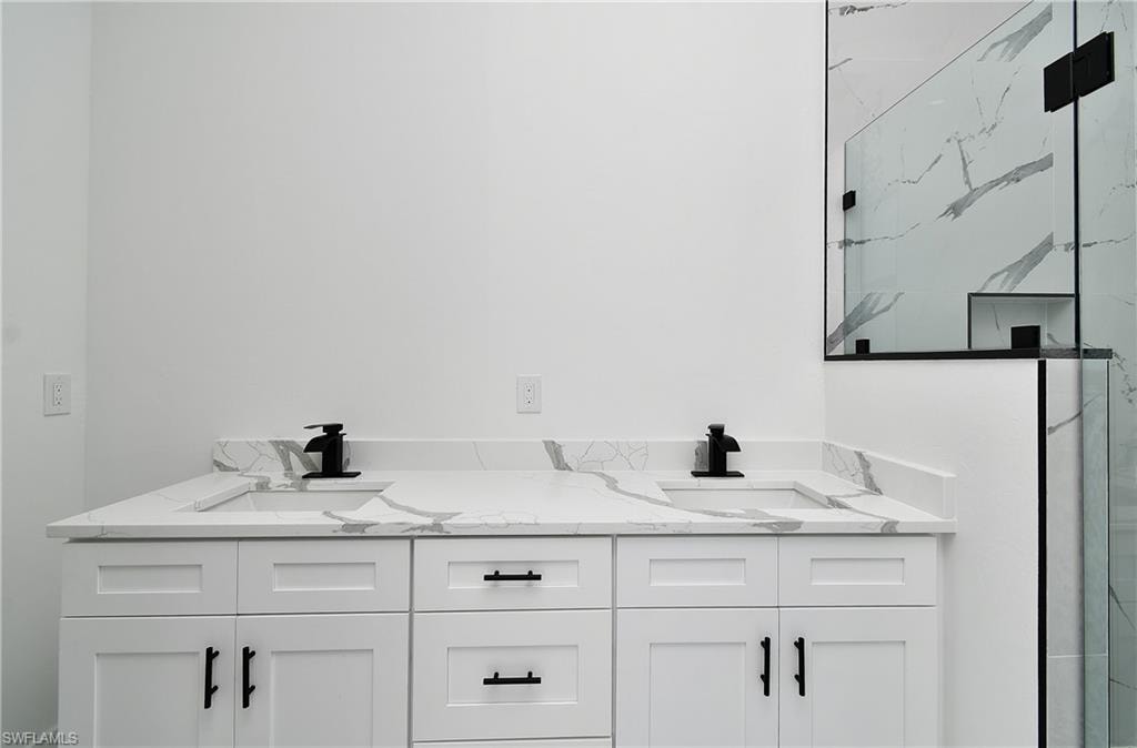 Dual vanity with white cabinetry and black hardware