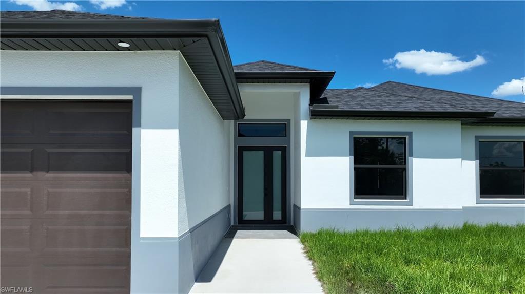 Contemporary stucco exterior with a dark shingle roof and contrasting gray trim