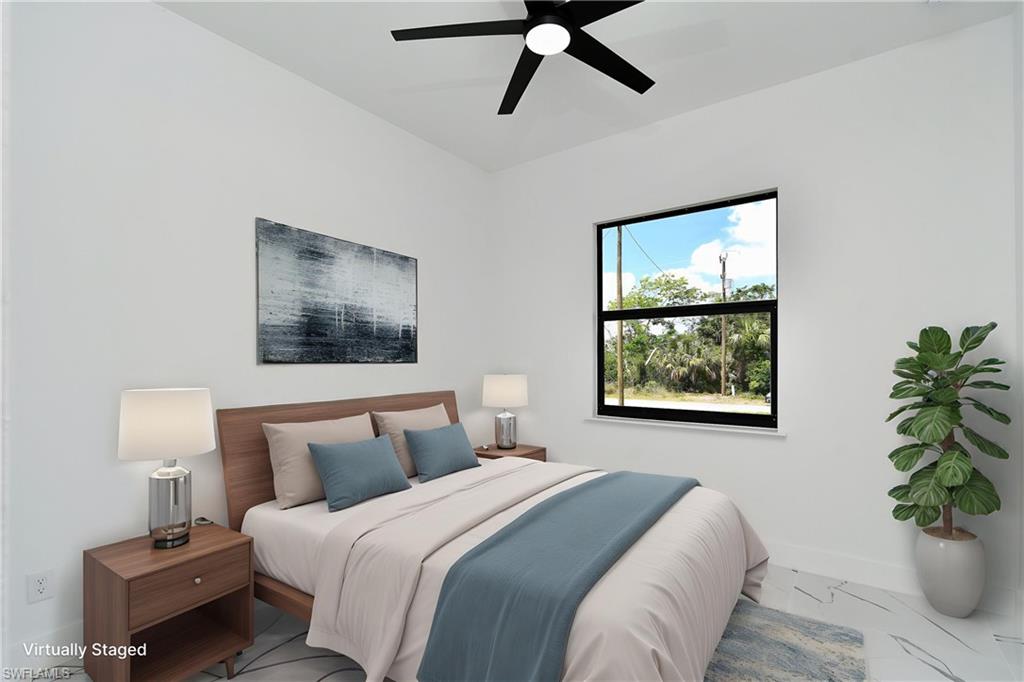 Bright room featuring a ceiling fan, a window with exterior views, and light-toned flooring