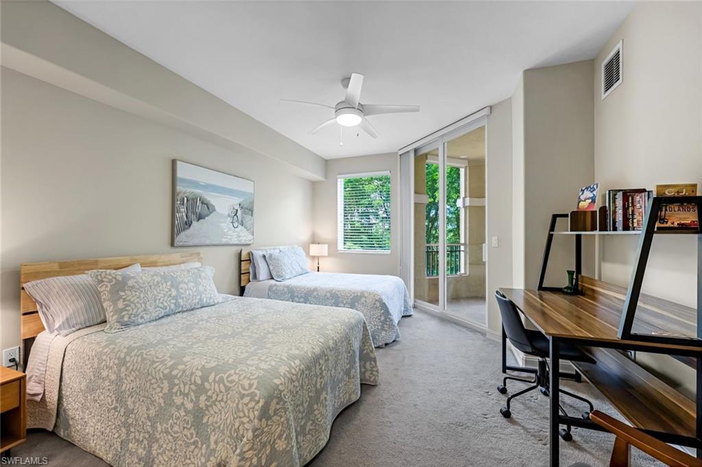 Carpeted bedroom with access to exterior and ceiling fan
