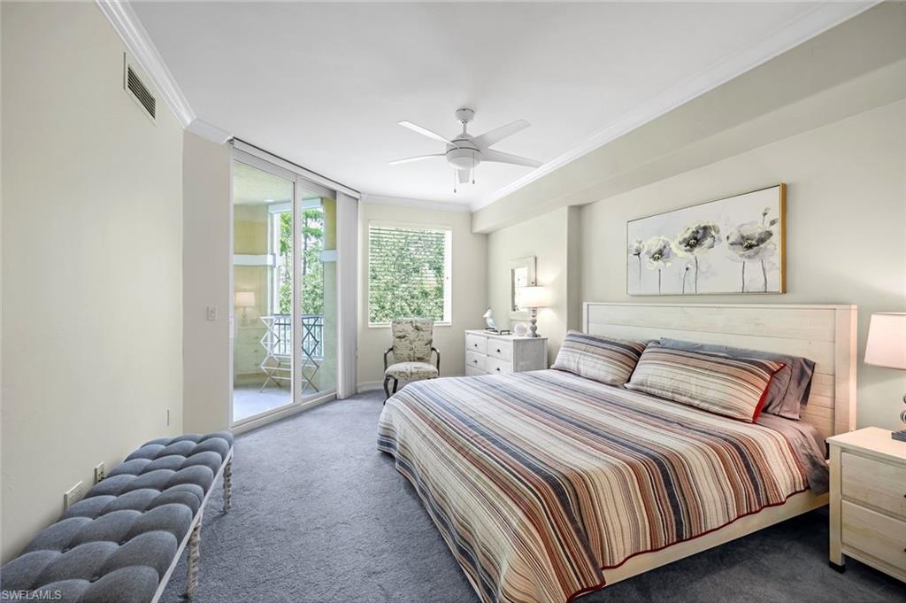Carpeted bedroom with access to outside, ceiling fan, and ornamental molding