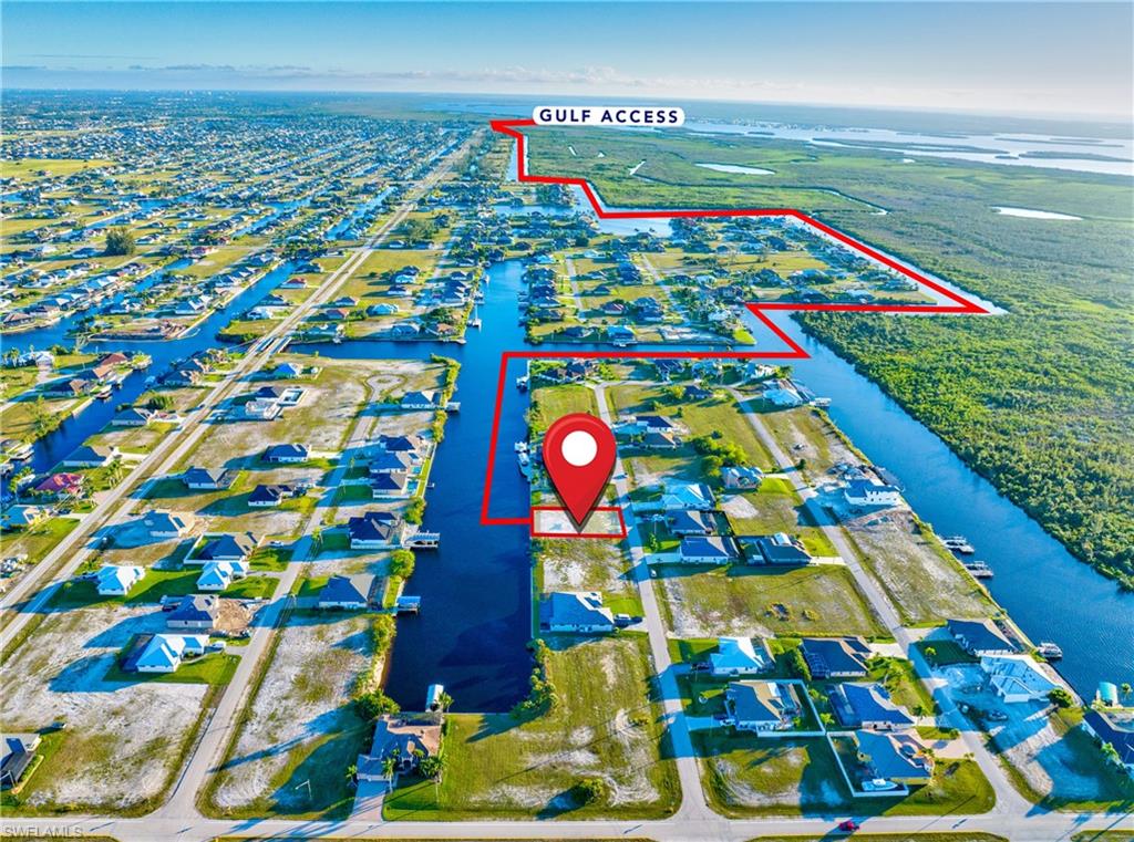 Canal-front property with direct Gulf access, featuring a waterfront lot ready for development