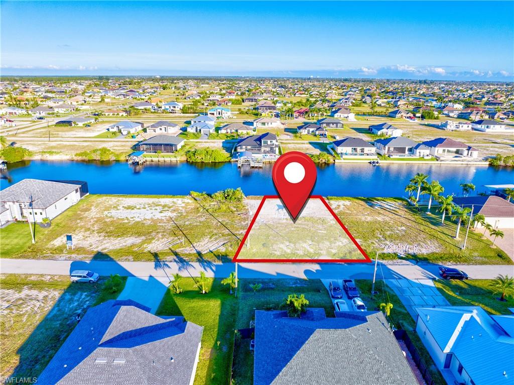 Canal-front lot featuring clear boundaries, direct water access, and proximity to established residences