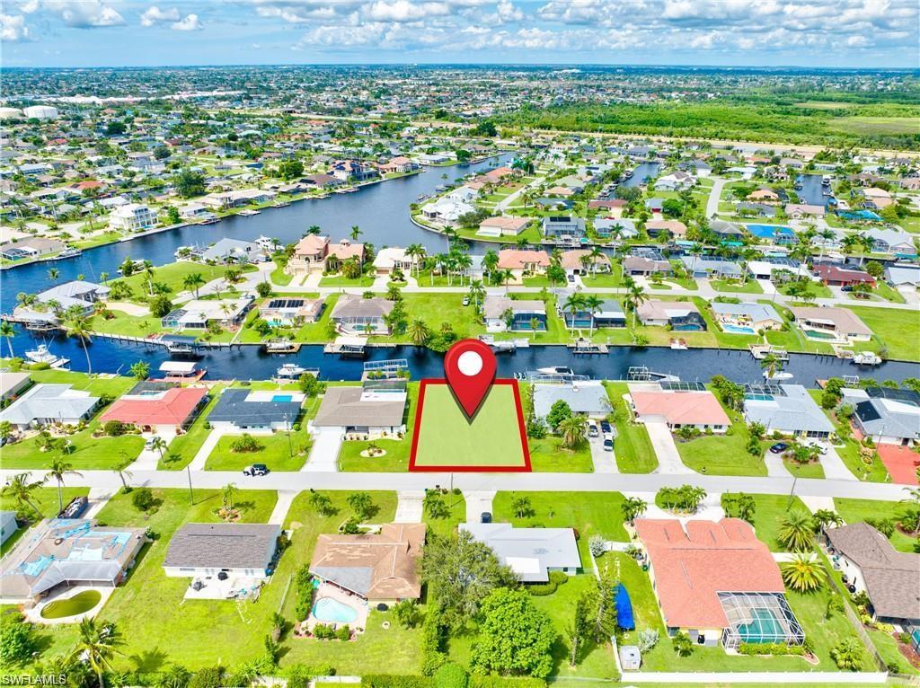 Residential lot featuring green space and street frontage in a canal-front community
