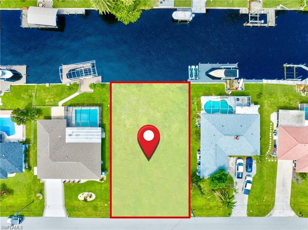 Cleared residential lot bordered by a red outline, featuring a flat, grassy terrain