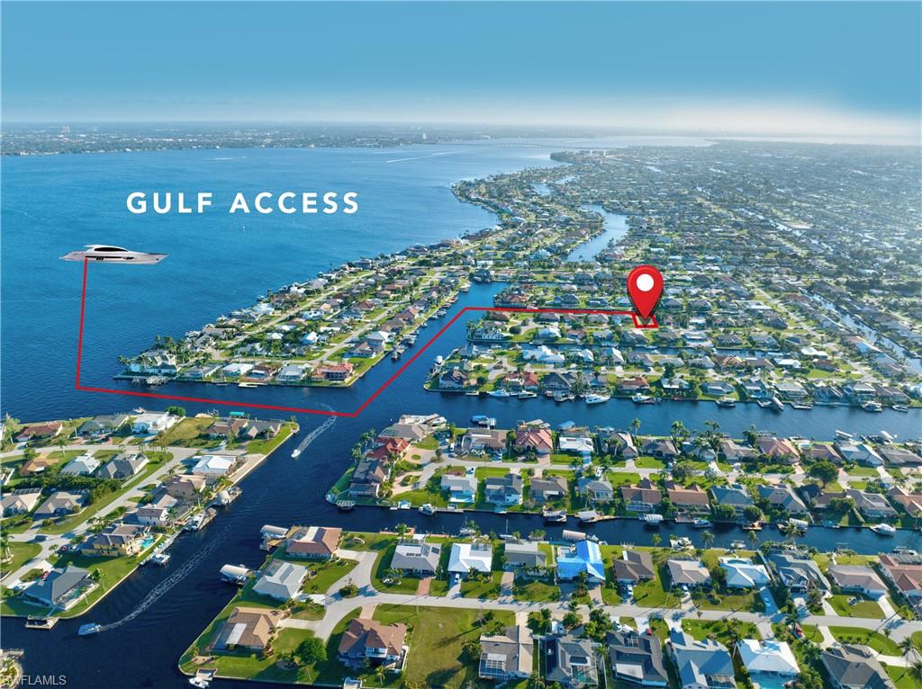 Aerial view of a coastal neighborhood featuring waterfront properties with private boat docks