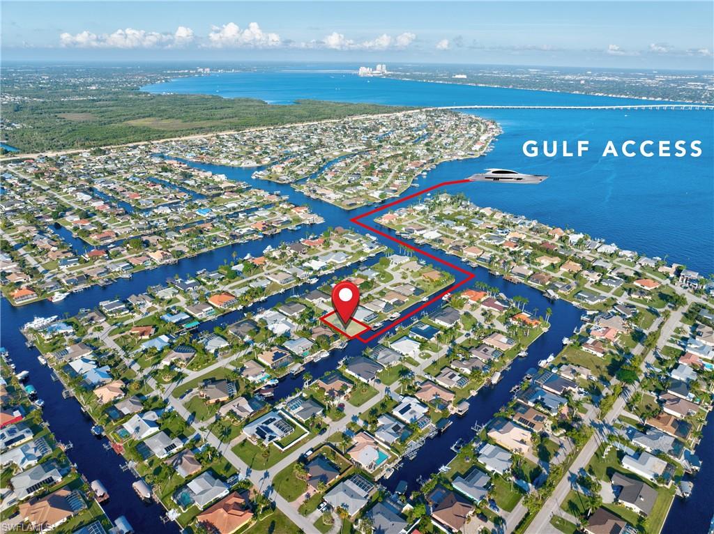 Waterfront community with extensive canal system, direct Gulf access, residential properties, and surrounding natural landscapes