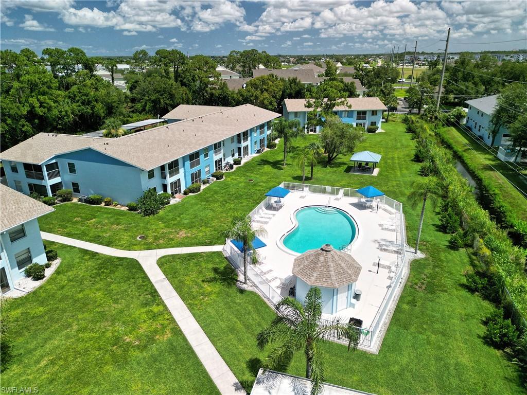 Centrally located swimming pool with surrounding lounge areas and a shaded cabana