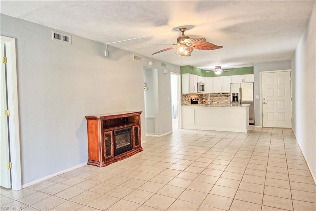Open-concept living space featuring tiled flooring and a ceiling fan