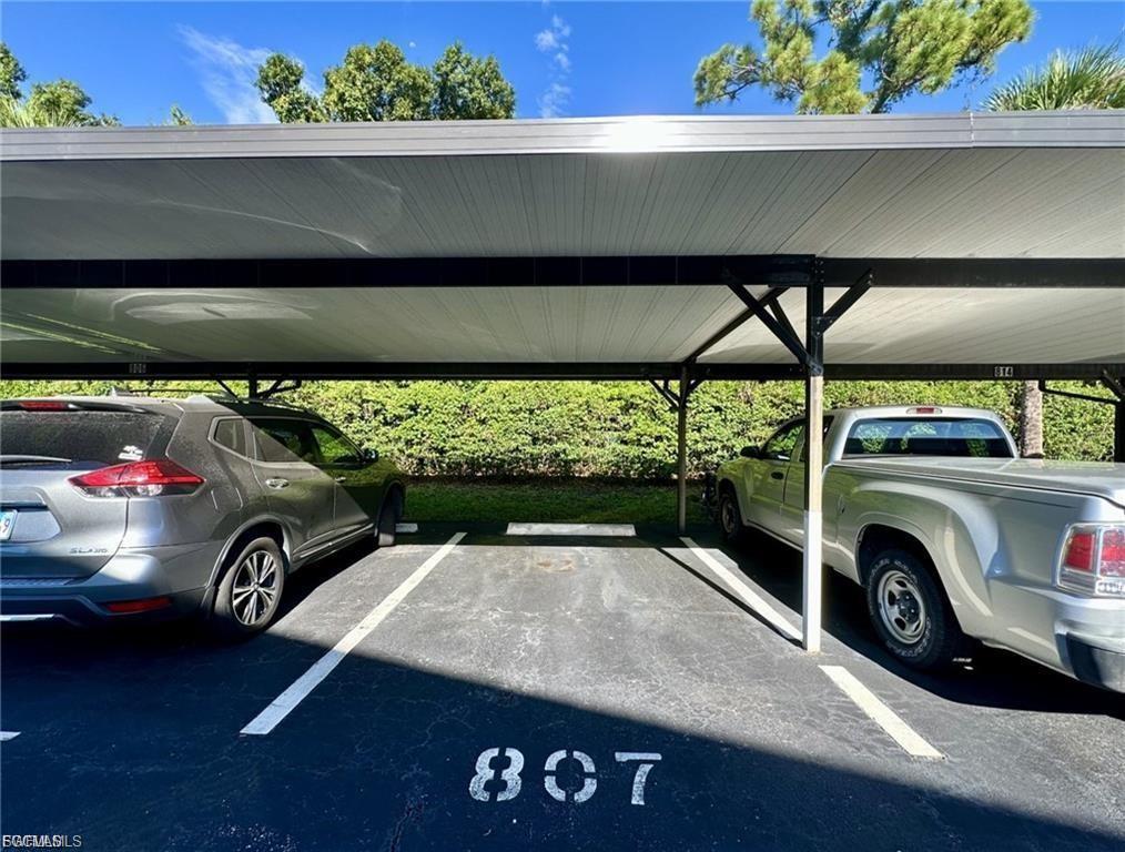 Covered parking space with painted numerical designation and white striped boundaries
