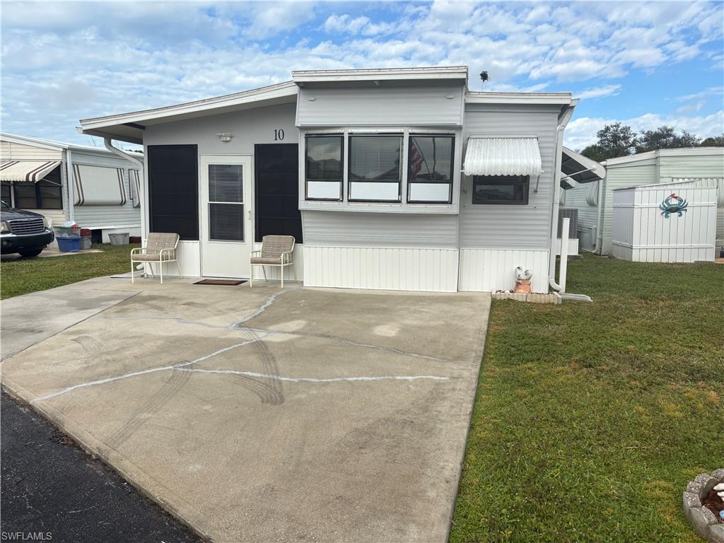 FRONT of property with a yard