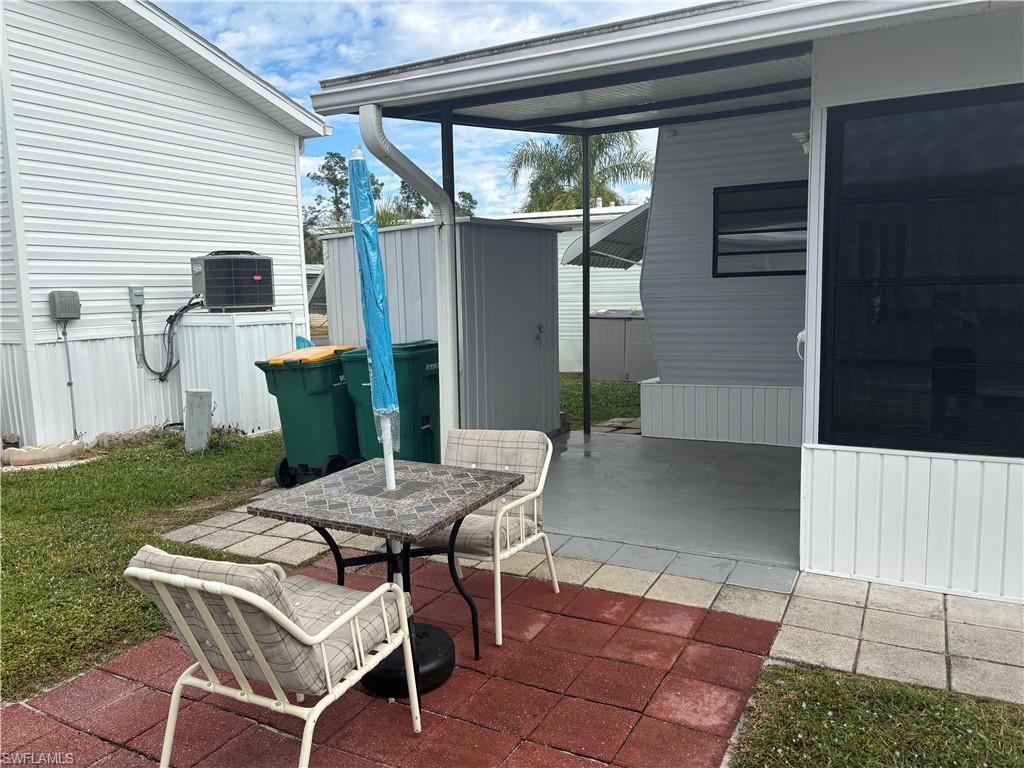 View of patio / terrace with a storage shed and outdoor dining area