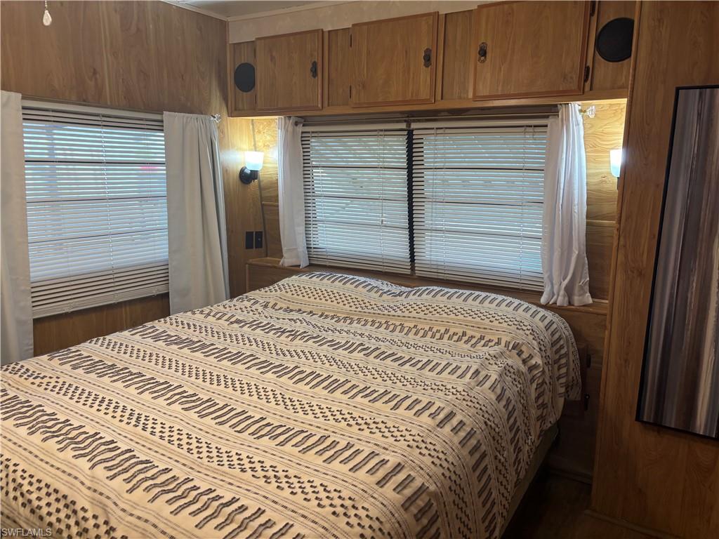 Bedroom with wood walls