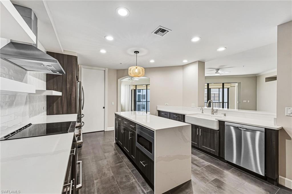 From the kitchen, a pass-through window artfully frames and connects the living spaces, creating an elegant flow perfectly suited for seamless entertaining and elevated service.