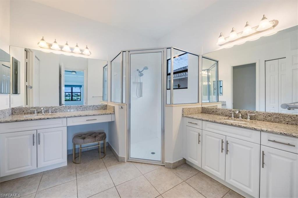 Bathroom with vanity, walk in shower, and tile patterned floors