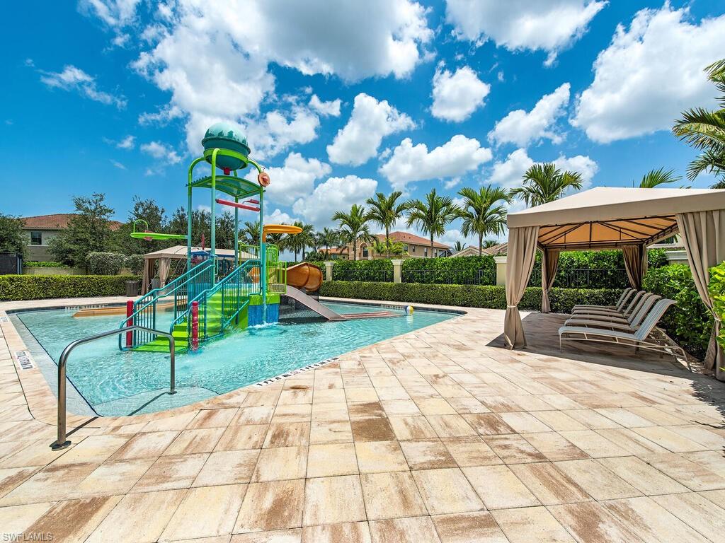 View of swimming pool with a patio, a water slide, a playground, and a gazebo