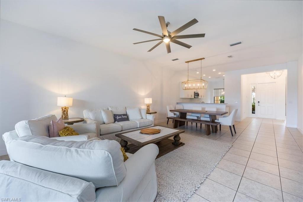 Tiled living room featuring ceiling fan