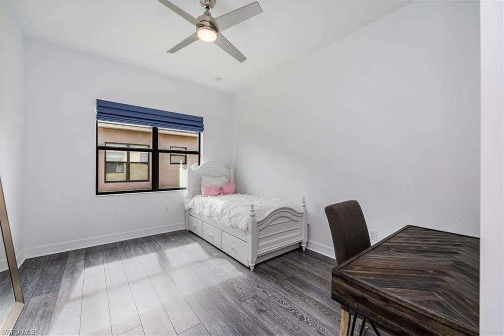 Bedroom featuring dark wood-type flooring and ceiling fan