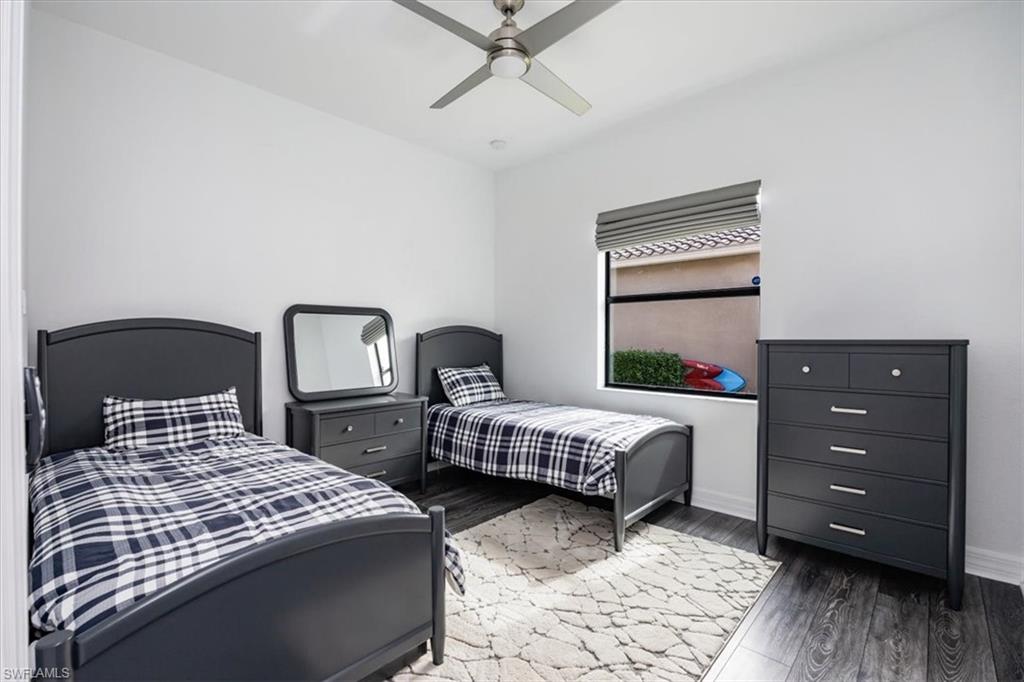 Bedroom featuring dark hardwood / wood-style flooring and ceiling fan