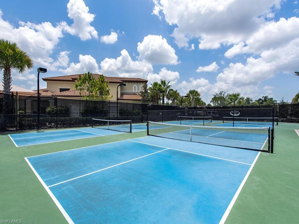 View of tennis court with basketball hoop