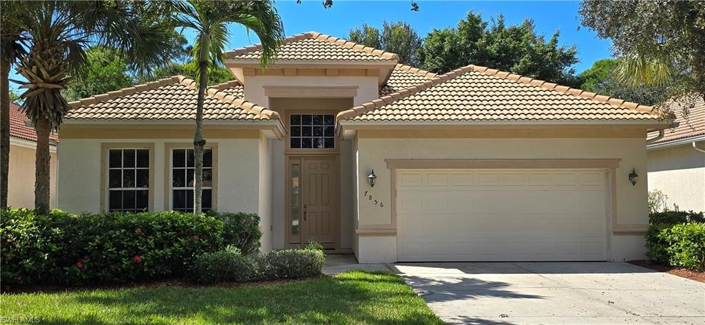 Mediterranean / spanish home with stucco siding, concrete driveway, a garage, and a tile roof