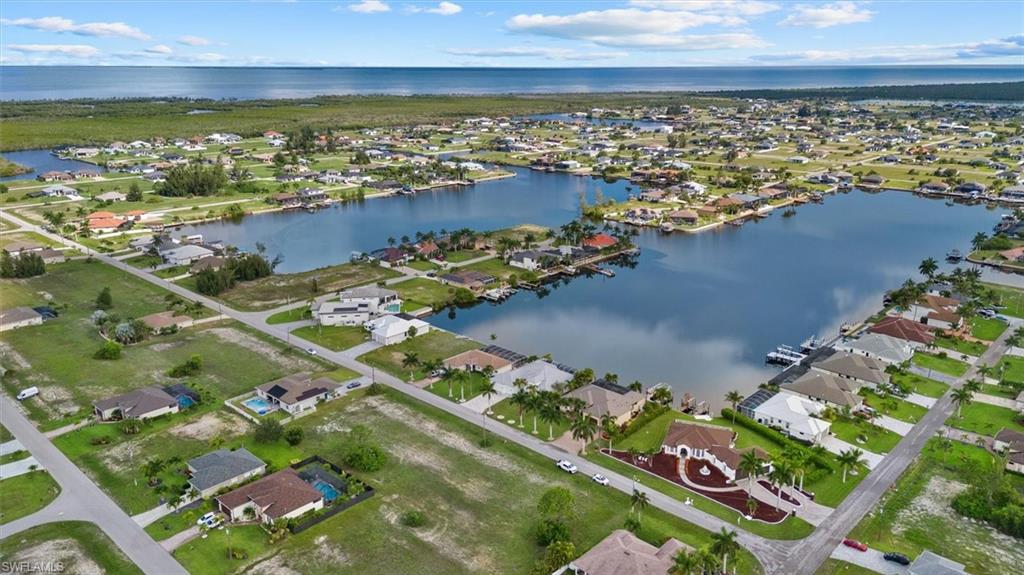 Aerial perspective showcasing a canal-front community with numerous properties