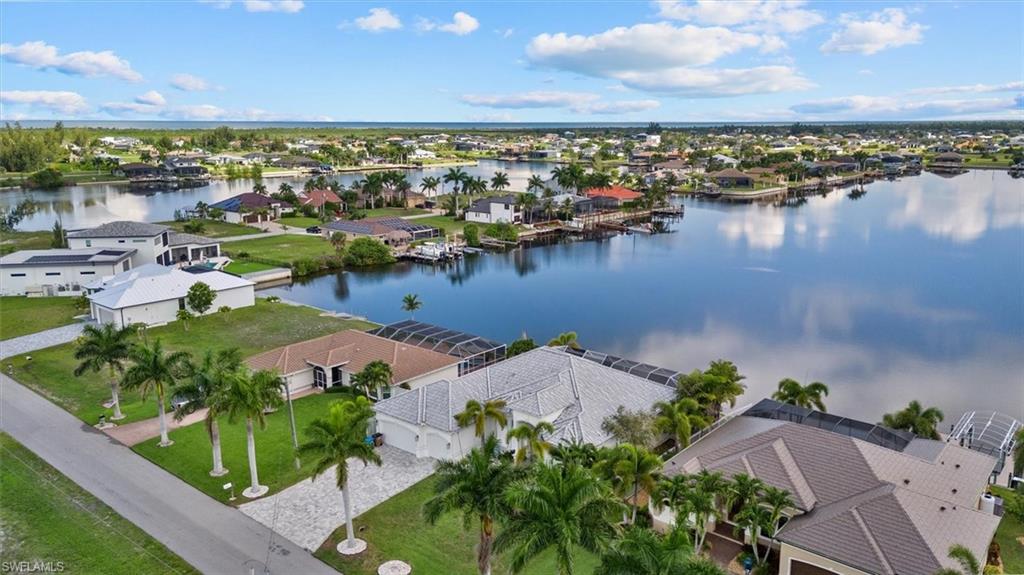 Waterfront property featuring direct canal access, an attached private dock, and a screened lanai
