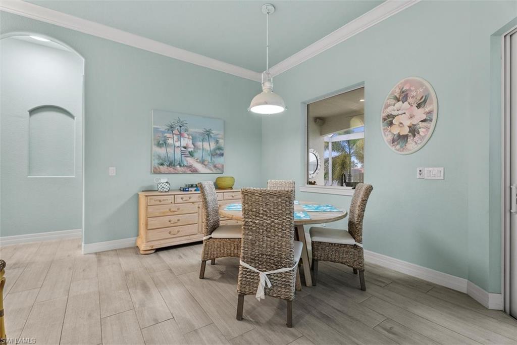 Dining area featuring wood-finish flooring and a built-in archway