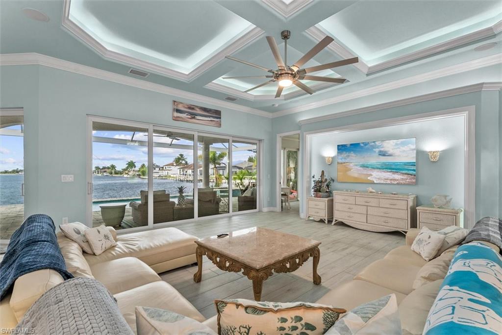 Spacious living area featuring expansive sliding glass doors opening to waterfront views