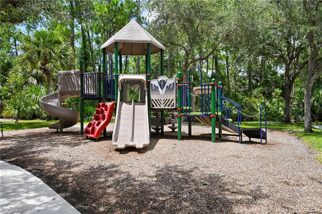 Multi-level playground structure featuring multiple slides, climbing elements, and a covered turret