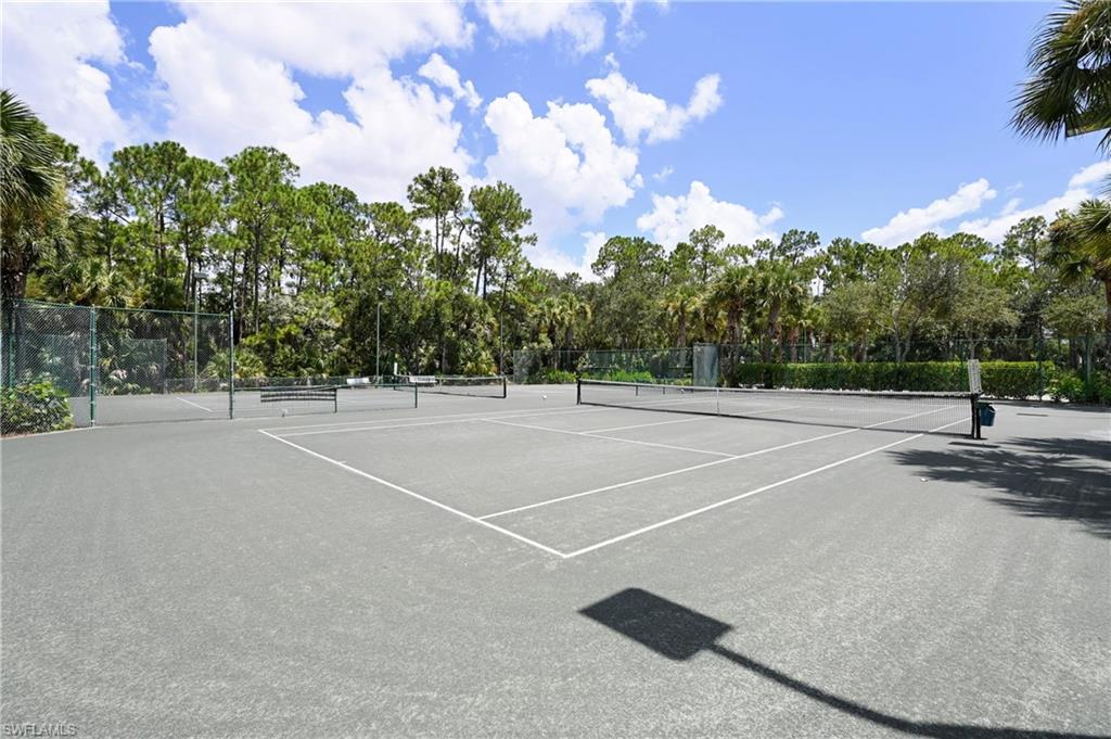 Outdoor tennis court with a hard surface and white court lines