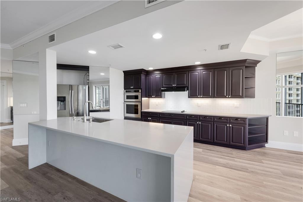 Open Kitchen featuring a large central island and stainless appliances