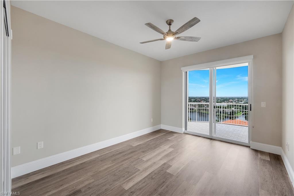 Bedroom #2 featuring wood-finish flooring and a ceiling fan