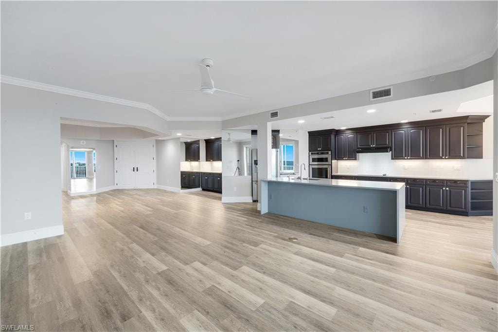 Expansive open-concept living area featuring wood-finish flooring throughout