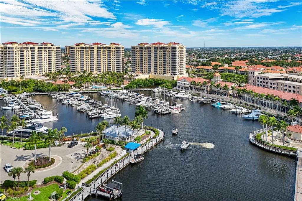 Expansive marina featuring multiple boat slips and a manicured waterfront promenade