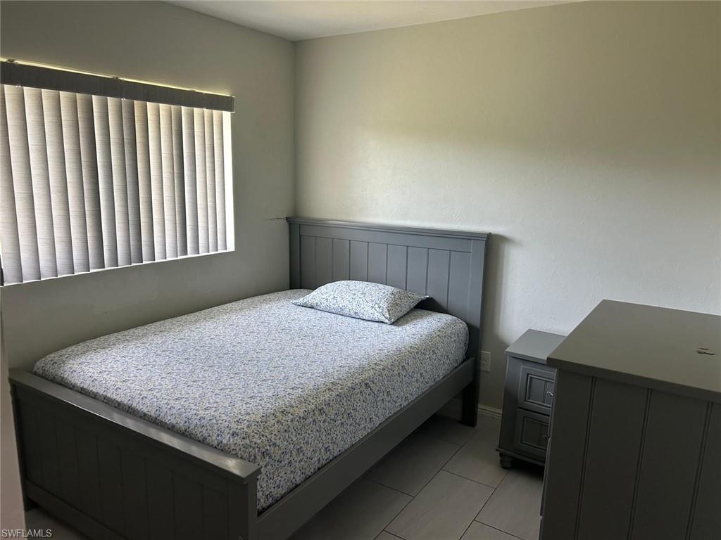 Room featuring light gray painted walls and tile flooring
